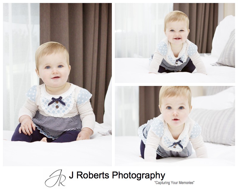 Smiling little girl on white bed - family portrait photography sydney