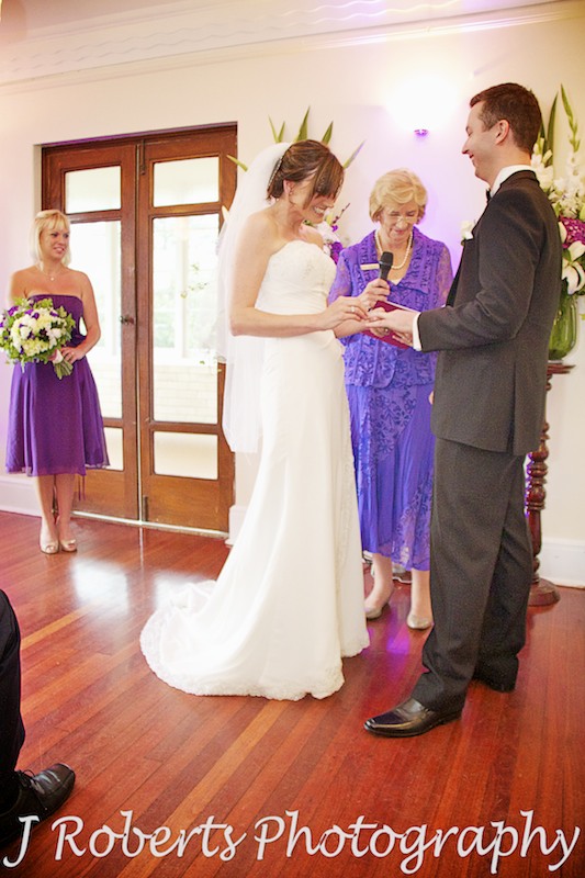  bride putting ring on groom's finger wedding photography sydney