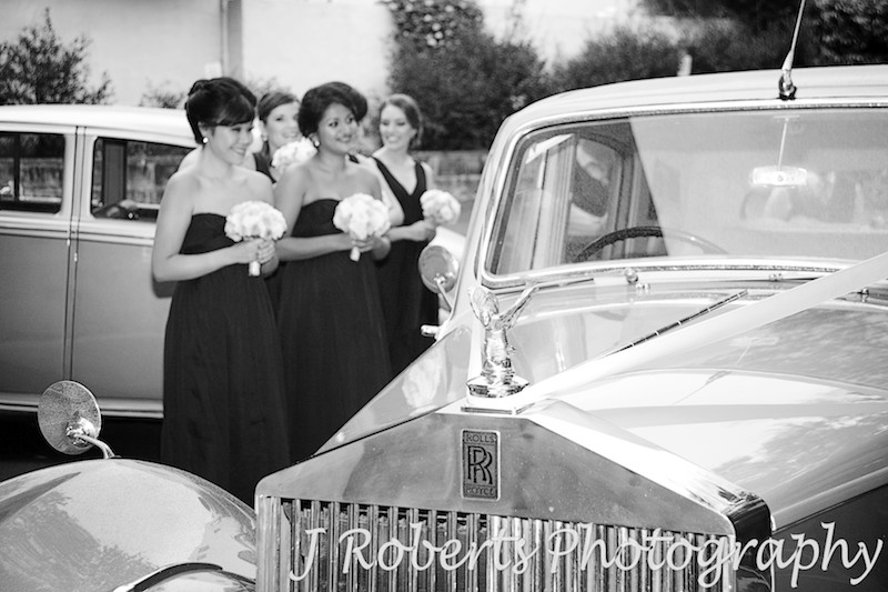 Rolls Royce bridal car with bridesmaids in the background wedding 